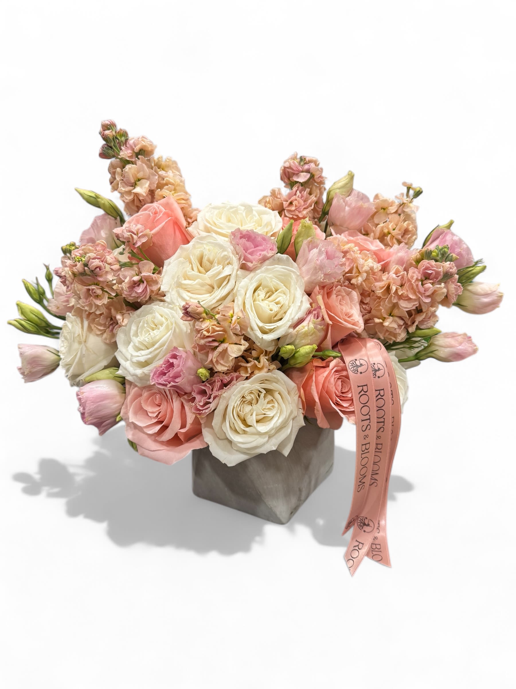 Pink and white rose bouquet in a gray box with a ribbon