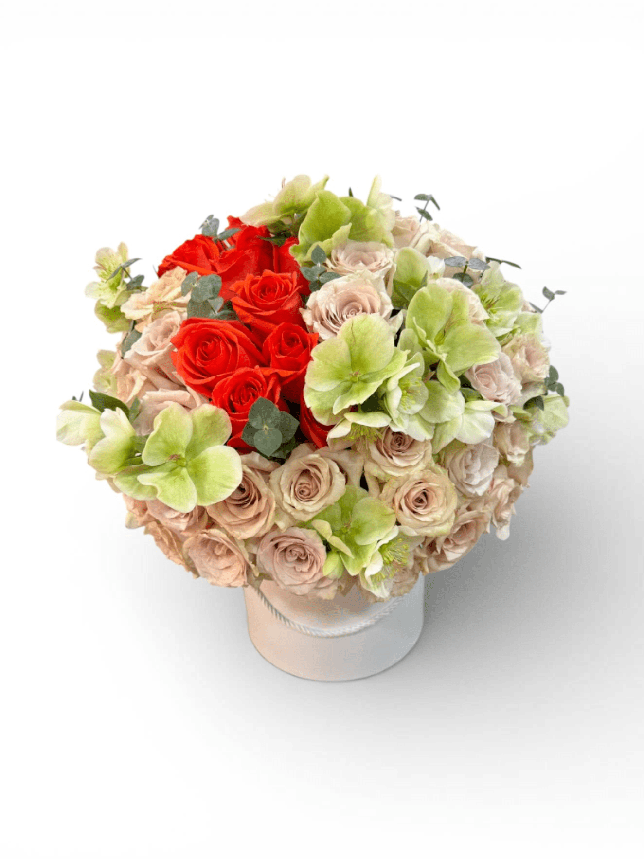 Bouquet of red and blush roses with pale green blooms in a white hat box