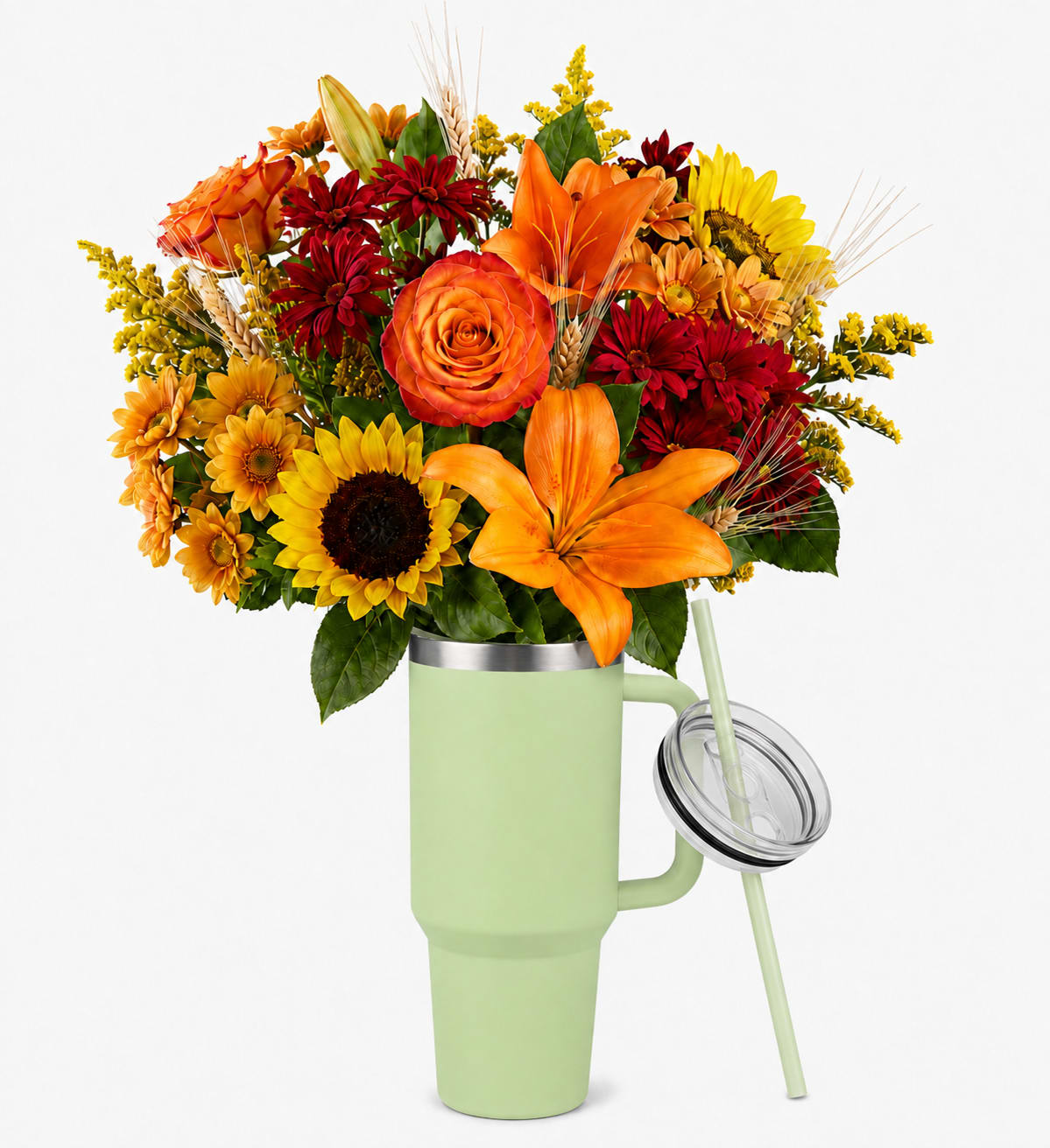 Bouquet of orange, red, and yellow flowers in a green tumbler vase