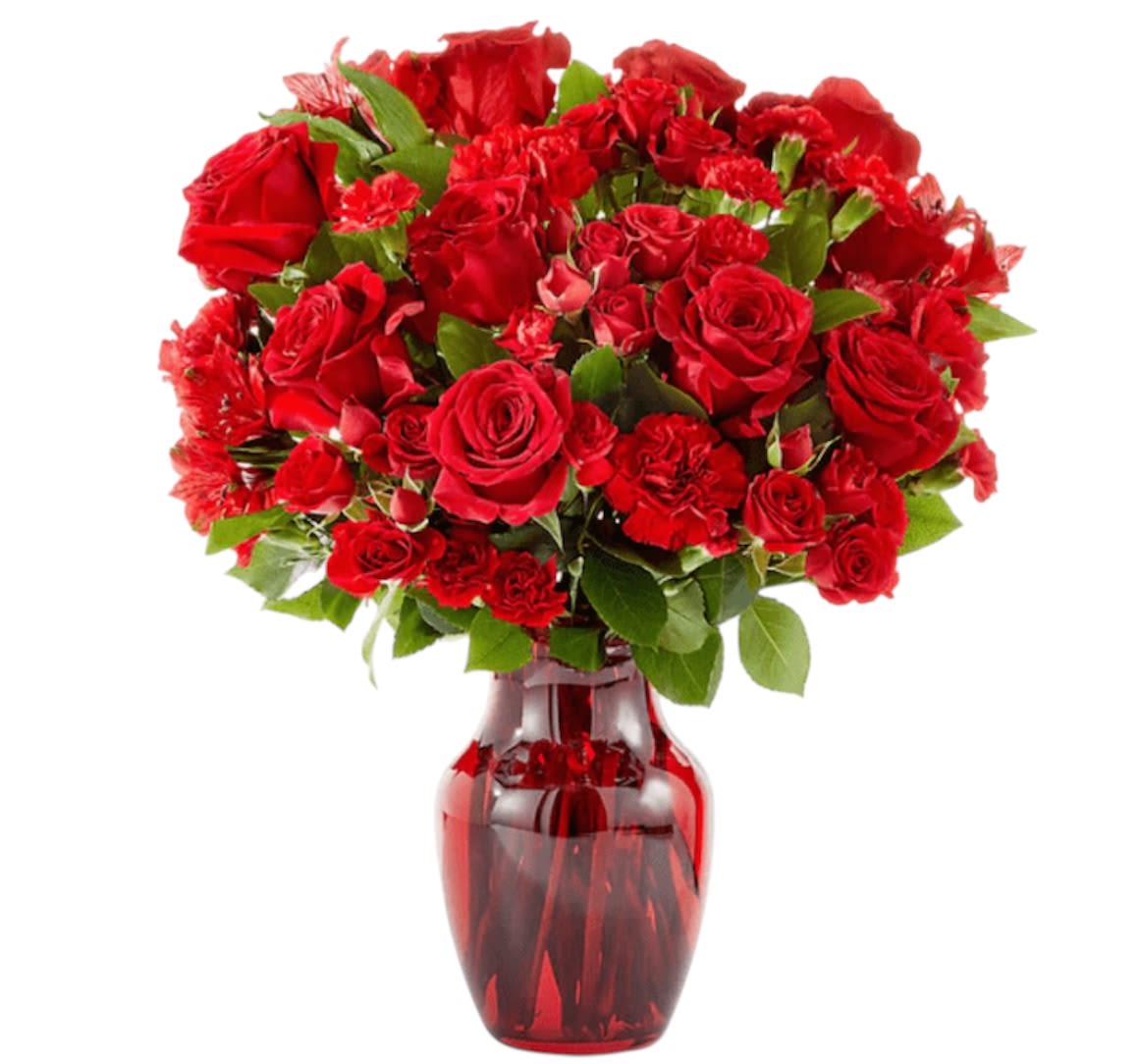 Red roses and carnations in a red glass vase