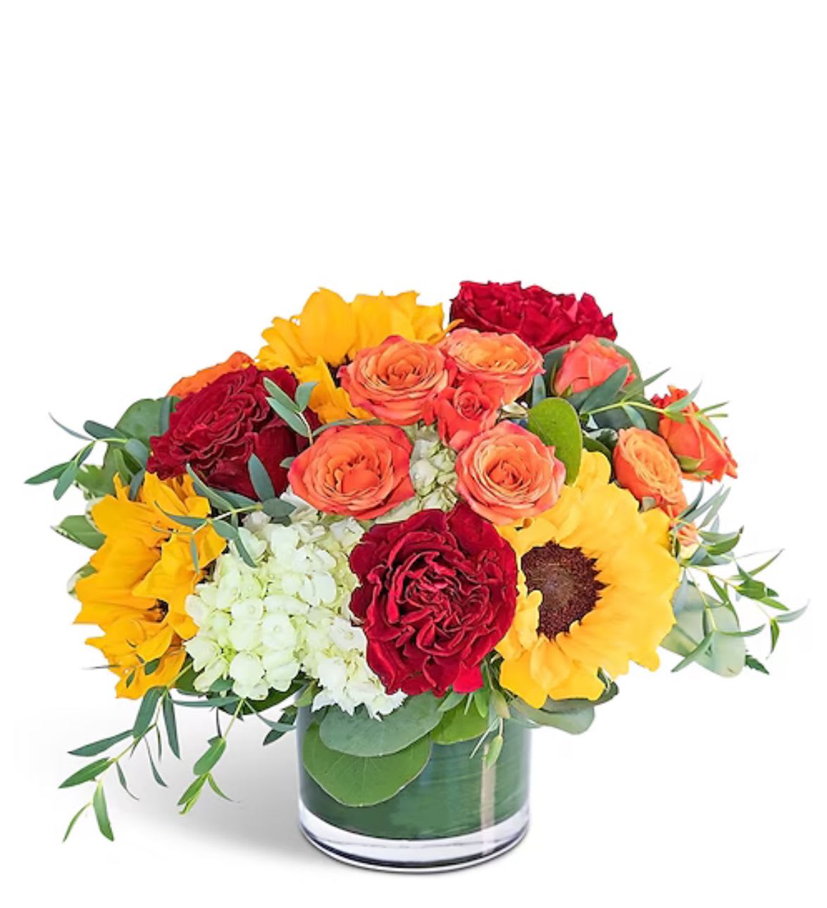 Bouquet of red and orange roses with yellow sunflowers in a glass vase