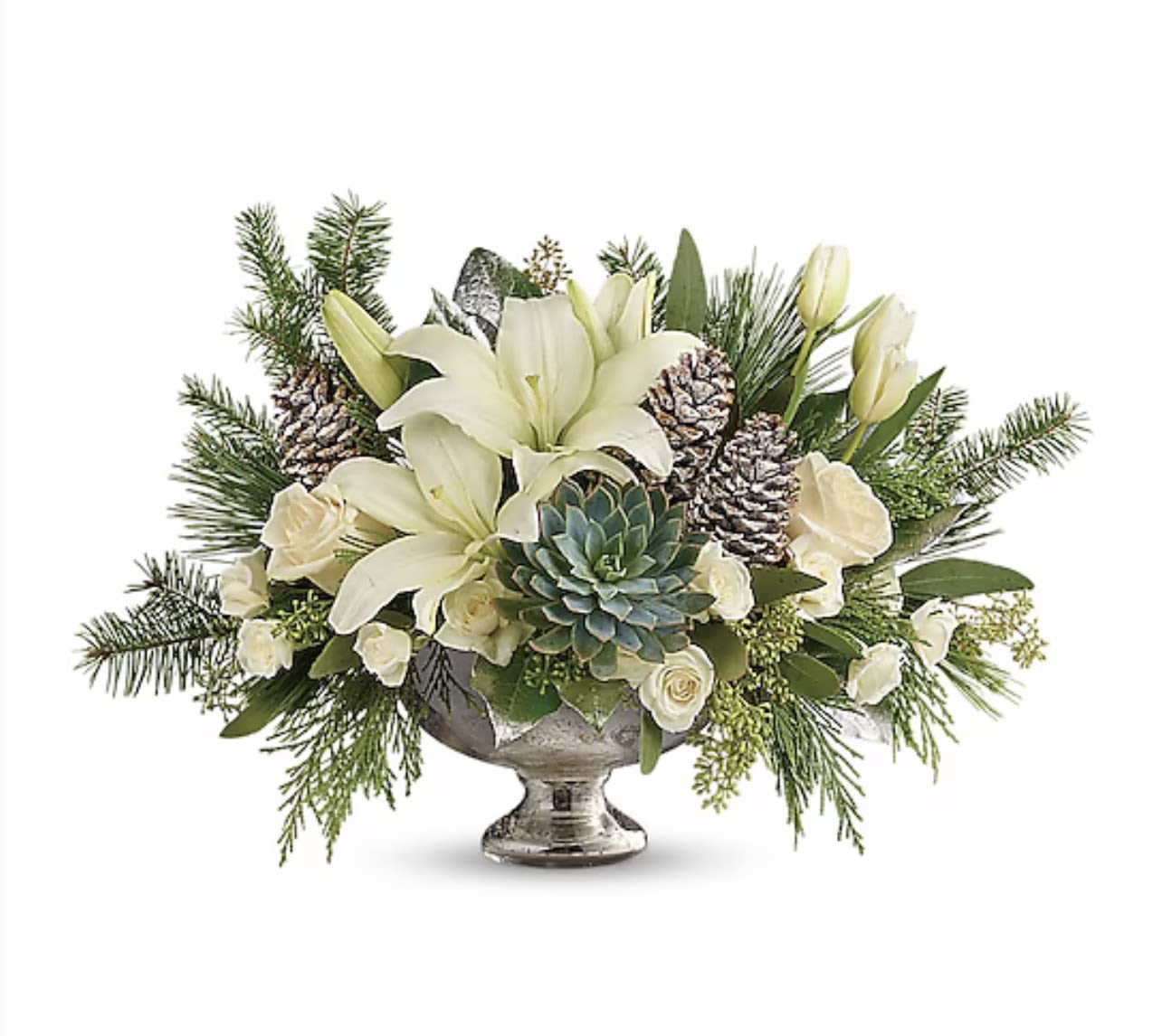White lilies and roses in a silver pedestal bowl with pinecones and greenery