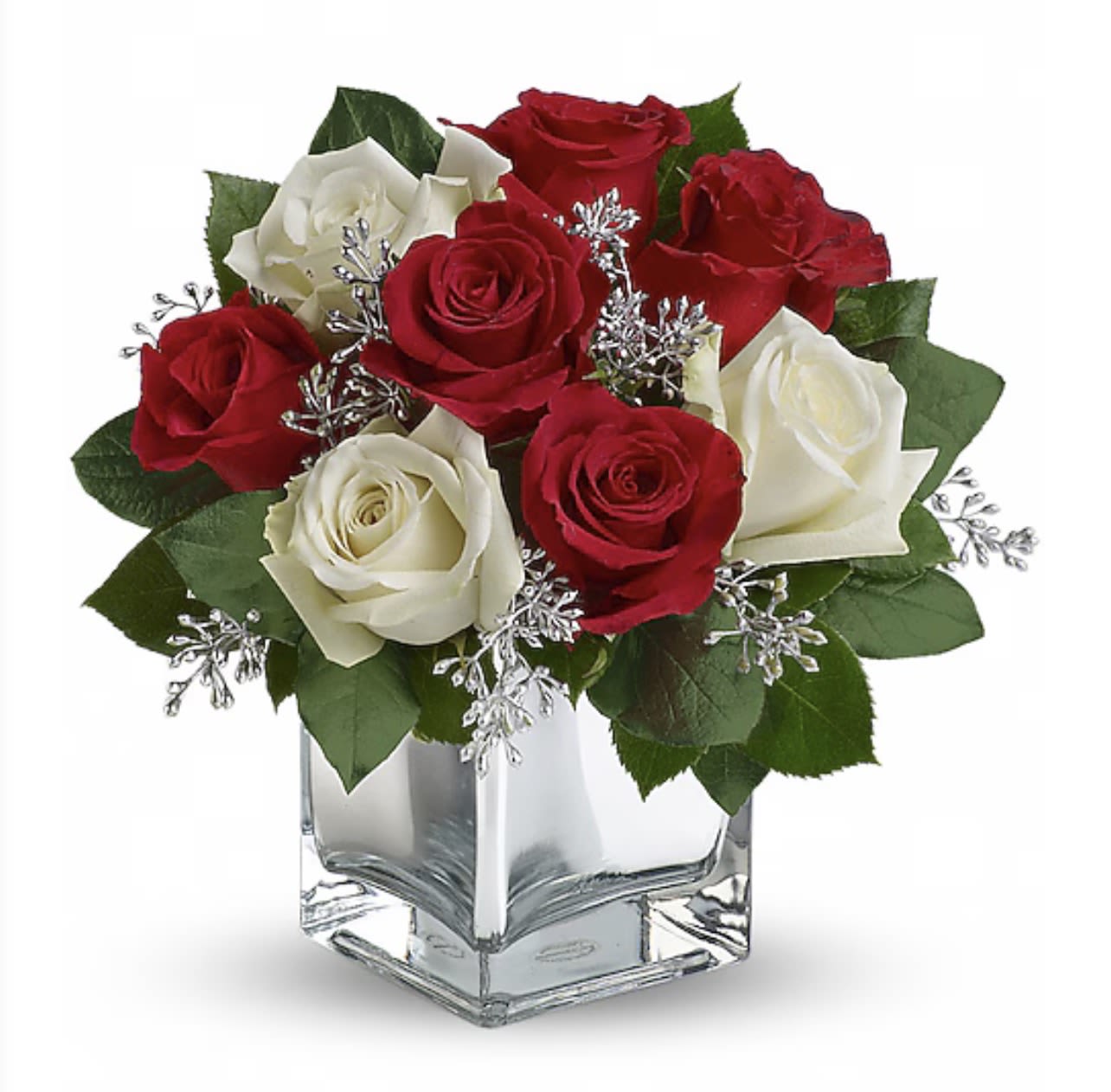 Red and white roses in a clear square vase