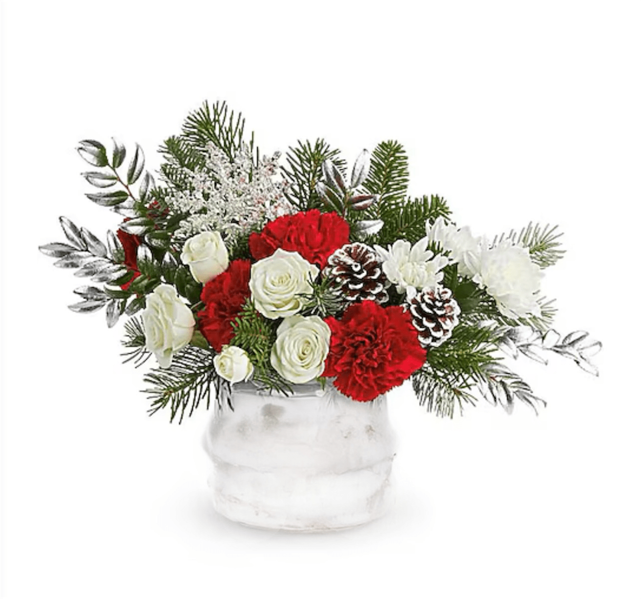 Red and white floral arrangement in a white vase with pinecones