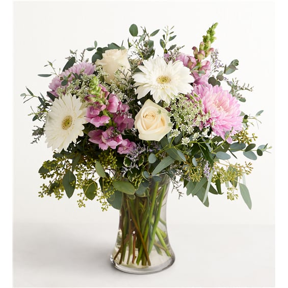 Bouquet of white and pink flowers in a clear glass vase