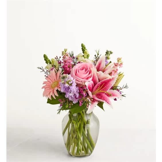 Pink mixed flower bouquet in a clear glass vase