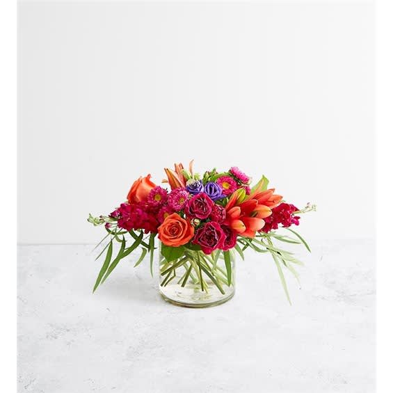 Bright mixed flower arrangement in a clear glass vase