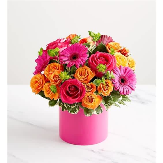 Bouquet of pink, orange, and yellow flowers in a pink vase