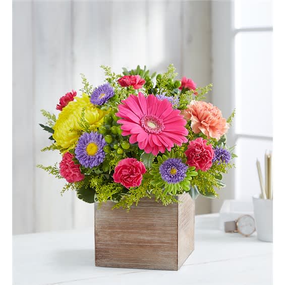 Colorful mixed flower arrangement in a wooden box