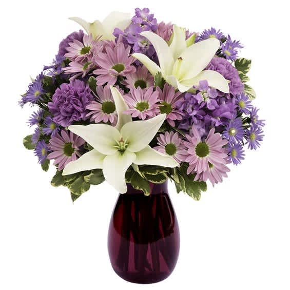 Bouquet of pink and purple flowers in a red glass vase