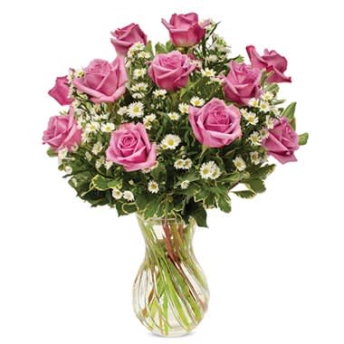Pink roses and white daisies in a clear glass vase