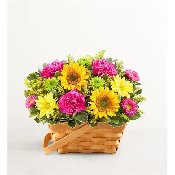 Basket of yellow sunflowers, pink carnations, and daisies