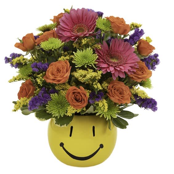 Bright mixed bouquet in a yellow smiley-face vase