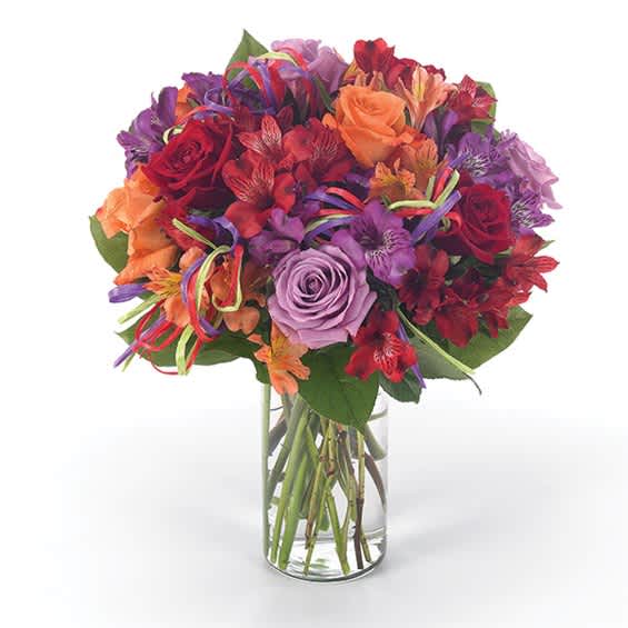 Mixed bouquet of roses and alstroemeria in a clear glass vase