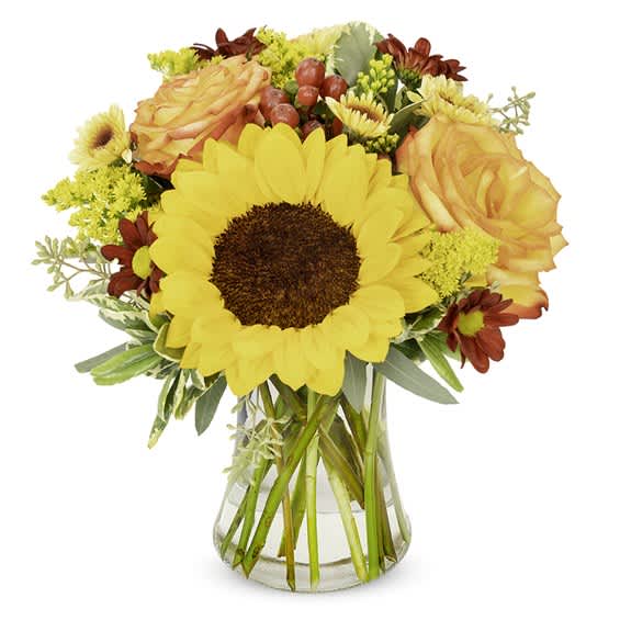 Sunflower and orange rose bouquet in a clear glass vase
