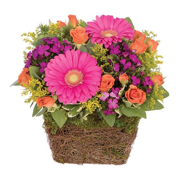 Pink gerbera daisies and orange roses in a woven basket