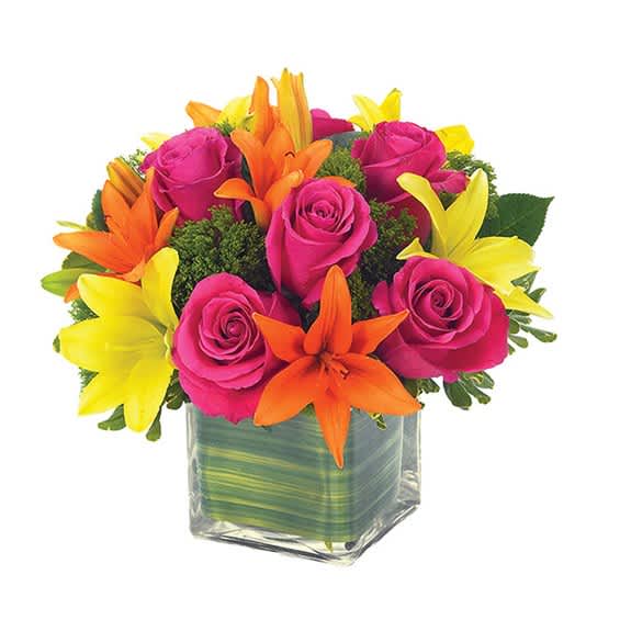 Pink roses and orange-yellow lilies in a square glass vase