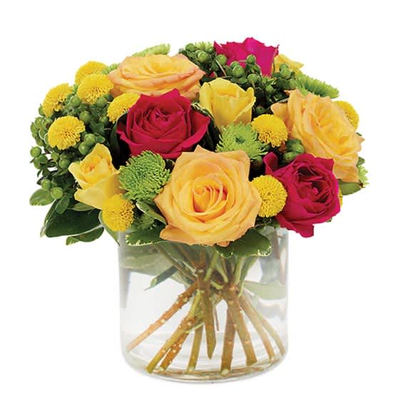Bouquet of pink and yellow roses in a clear glass vase