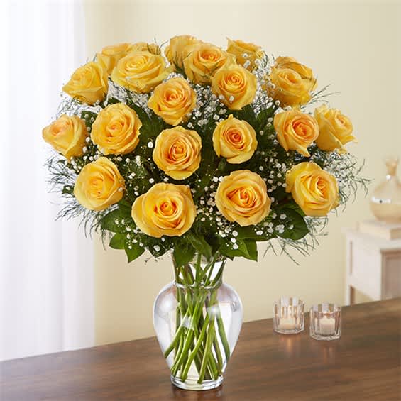 Yellow roses arranged in a clear glass vase