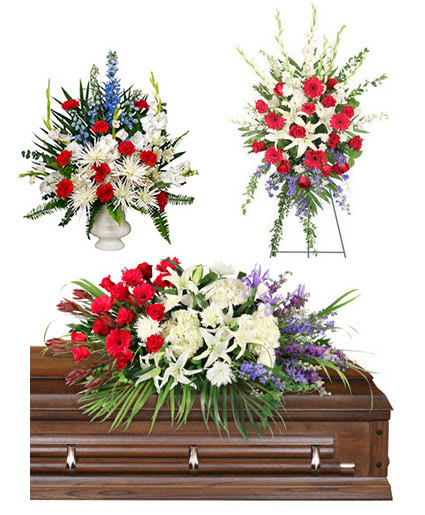 Three floral funeral sprays with red, white, and purple flowers on a casket