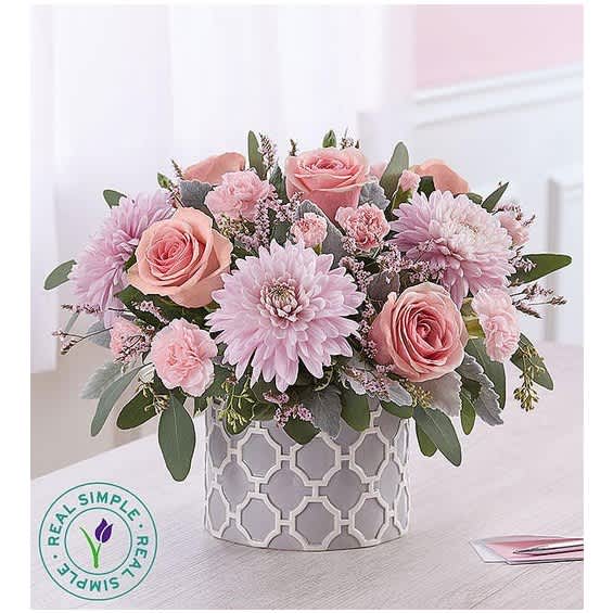 Pink roses and chrysanthemums in a patterned gray vase