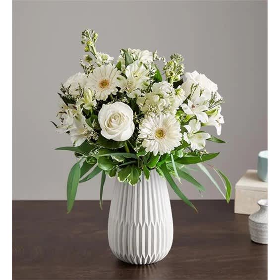 White floral bouquet in a ribbed white vase