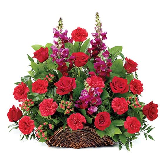 Basket arrangement of red roses and carnations with purple flowers