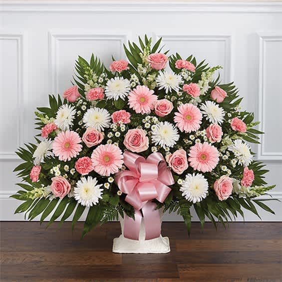 Pink and white floral spray with a pink ribbon bow