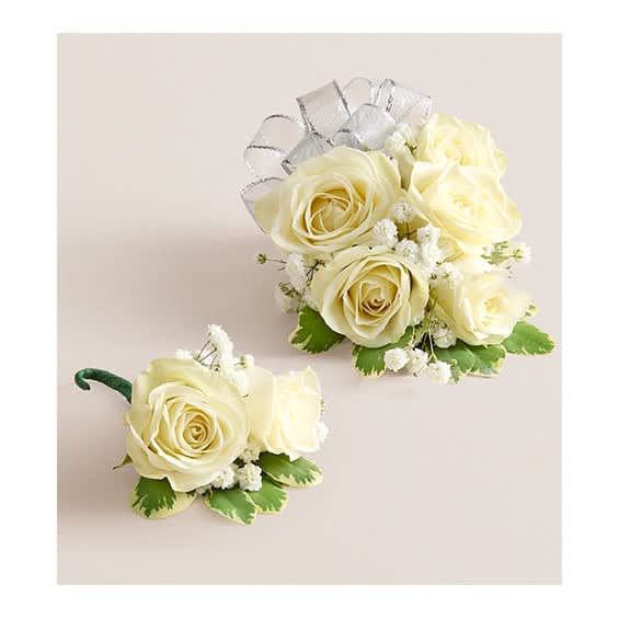 Cream rose corsage and boutonniere with silver ribbon and green accents
