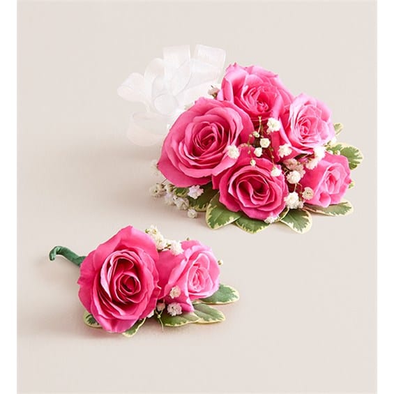 Pink rose corsage and boutonniere with white baby's breath