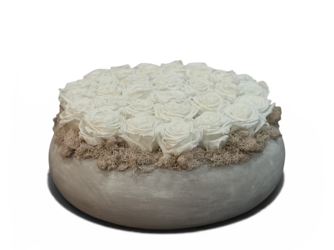 Eternal Ivory Dome - A refined arrangement of premium preserved ivory roses, meticulously set in a modern low-profile vessel and accented with natural textured elements. Designed to maintain its beauty for up to three years, this piece offers lasting elegance with zero maintenance. 