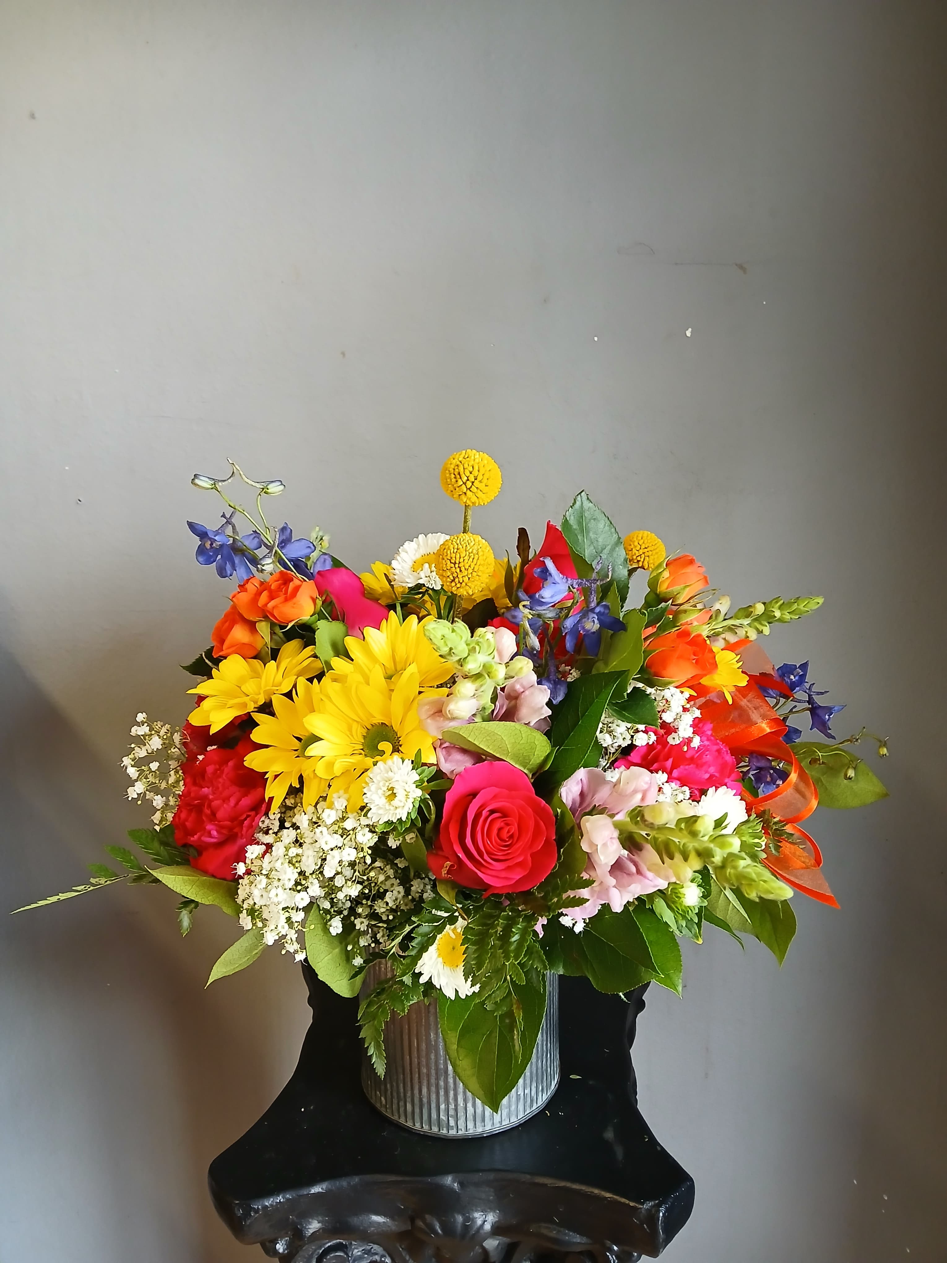Colorful mixed bouquet in a ribbed metal container