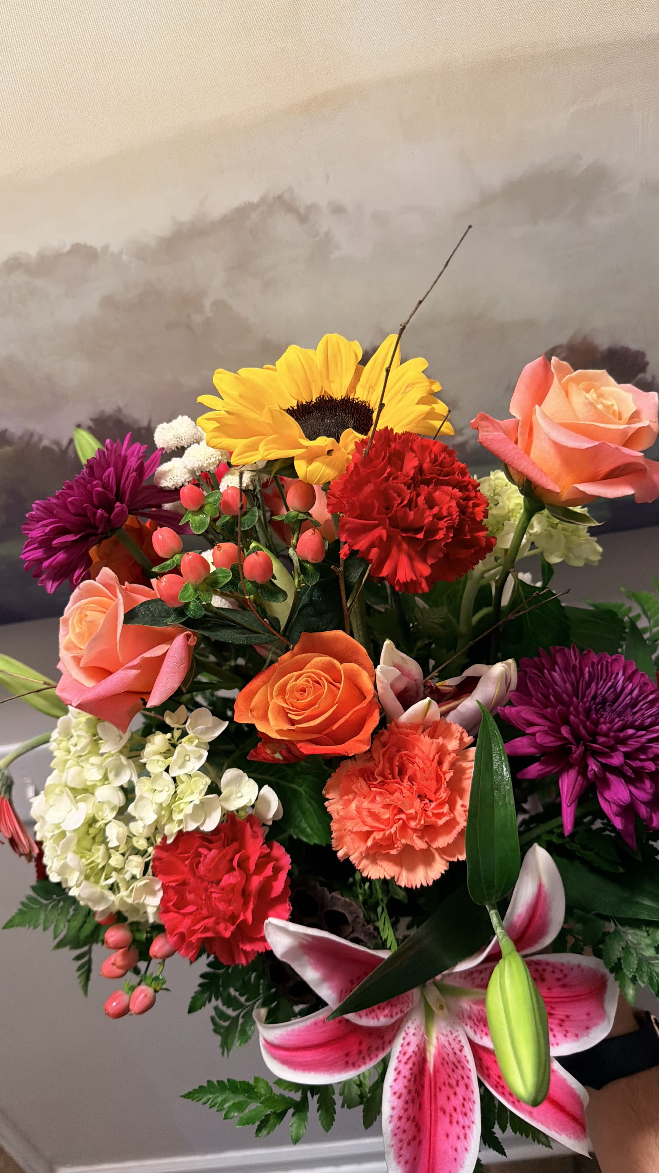 Mixed bouquet with roses, lilies, sunflowers, and carnations