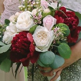 Bouquet of red and white roses with green foliage
