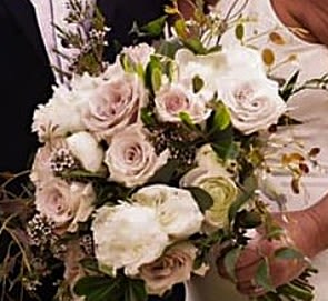 Bouquet of pale pink and white roses with greenery