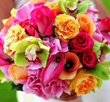 Bright mixed bouquet with roses and orchids in pink, orange, and green