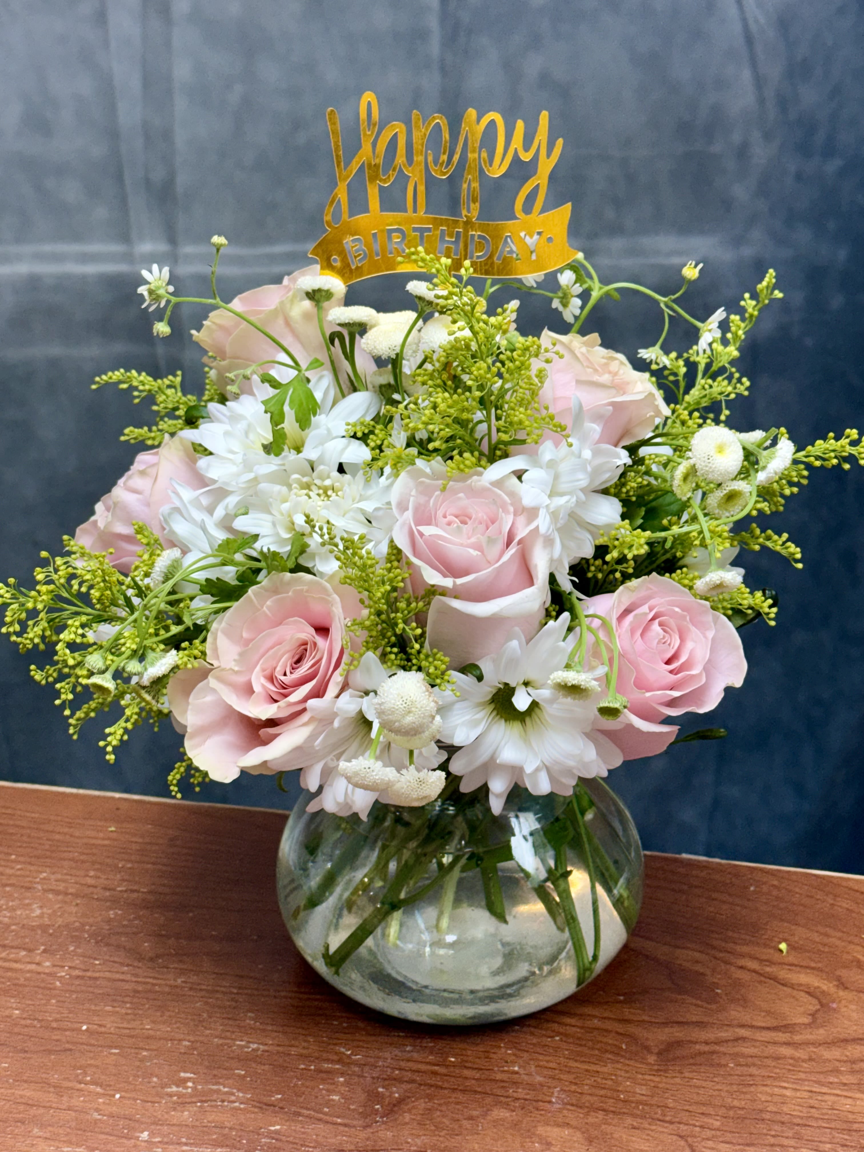 Spring Blooms - Celebrate the beauty of the season with Spring Blooms! This fresh flower arrangement features elegant pink roses, cheerful yellow daisies, and lush fillers, creating a bright and joyful display perfect for any occasion.