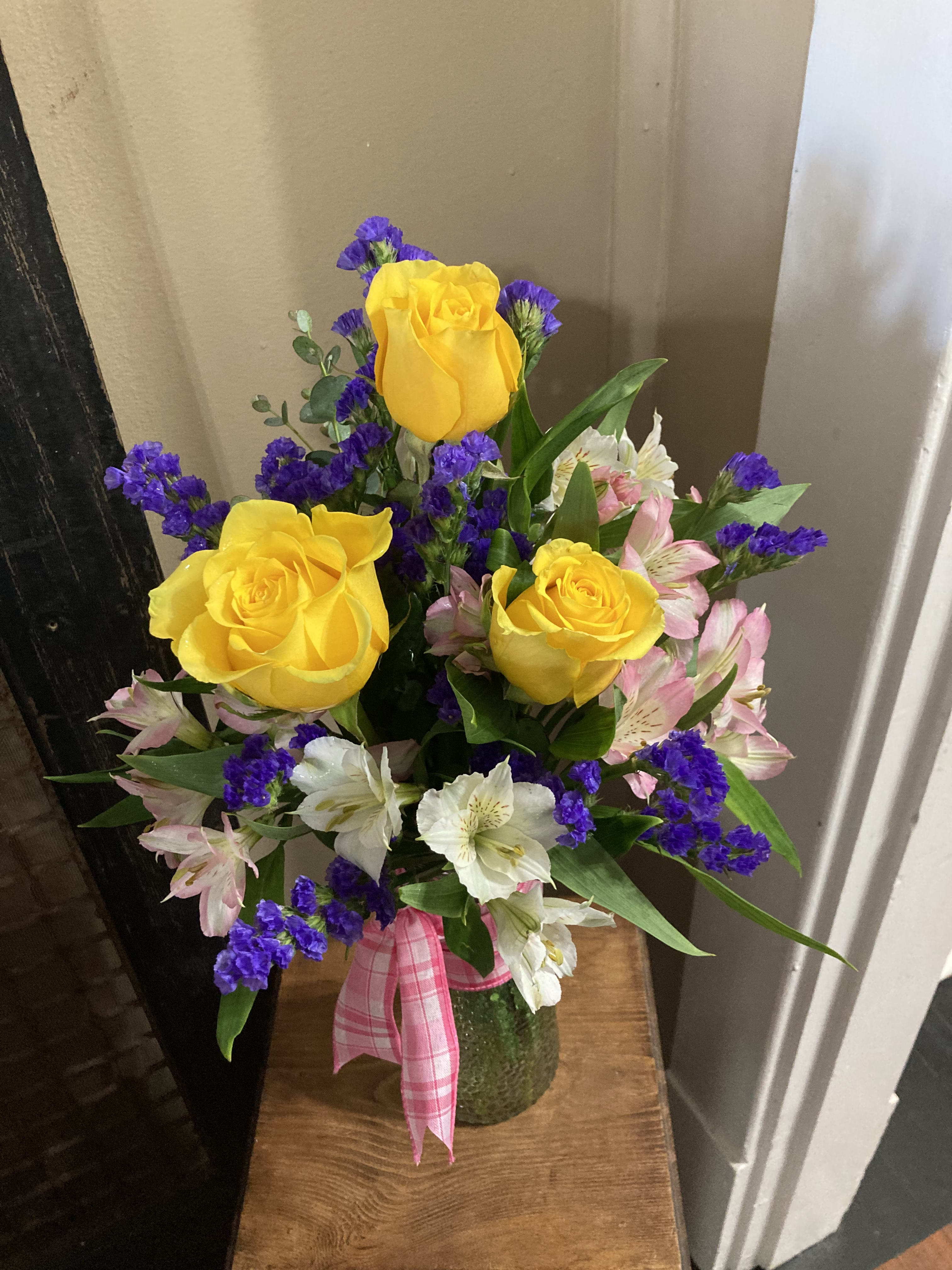 Happy Smiles 3 Rose Bouquet  -  Say a simple and sweet thank you for all the things they do behind the scenes. A bud vase of colorful filled with an assortment of 3 yellow roses, and pink and purple fillers.  ROSE AND FLOWER Colors can vary in every arrangement as this is a special made to order bouquet. PLEASE NOTE IF YOU HAVE A PREFERENCE OF ROSE COLORS.