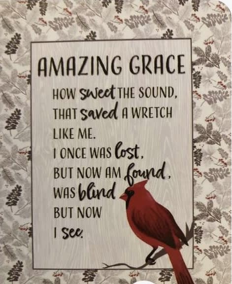 Decorative sign with a cardinal and religious text
