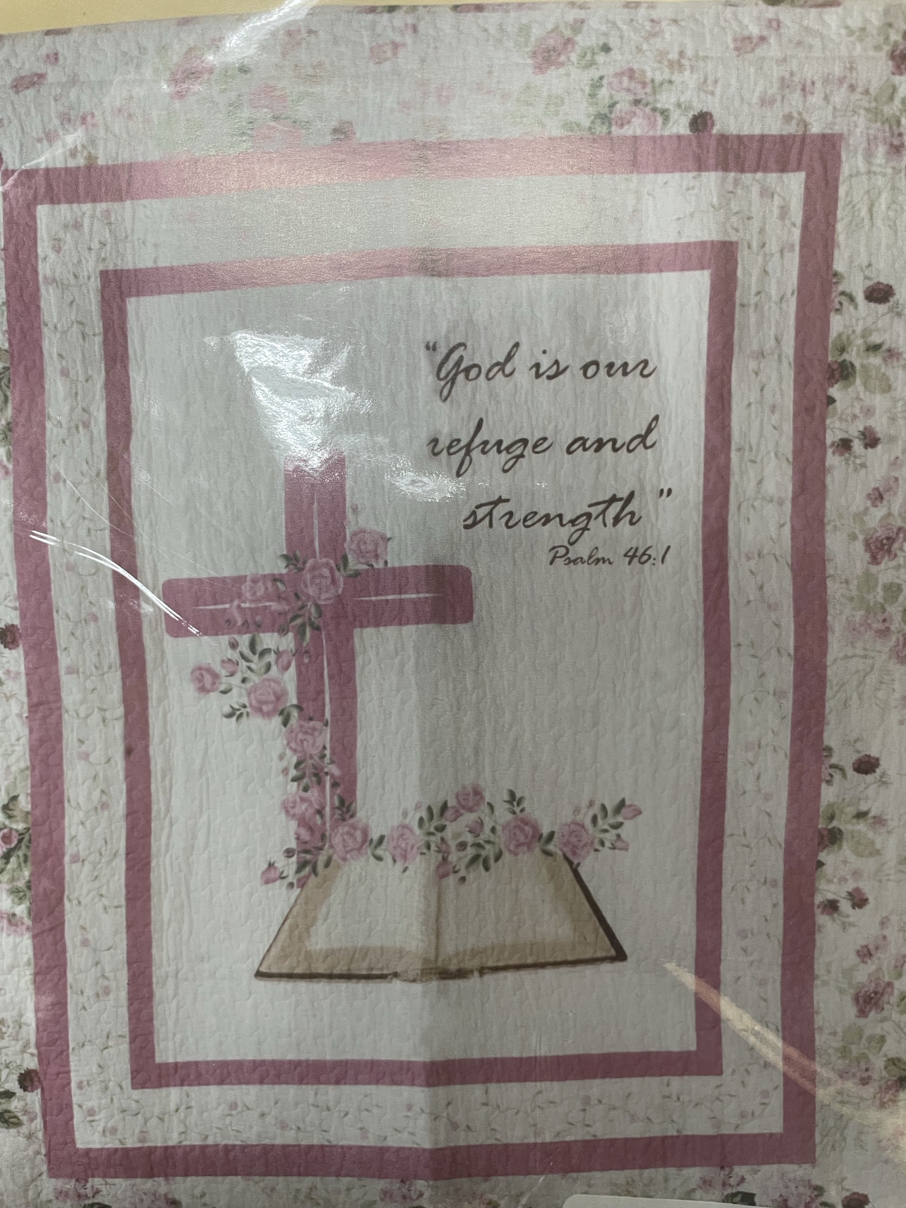 Quilt with a pink cross and Bible verse text