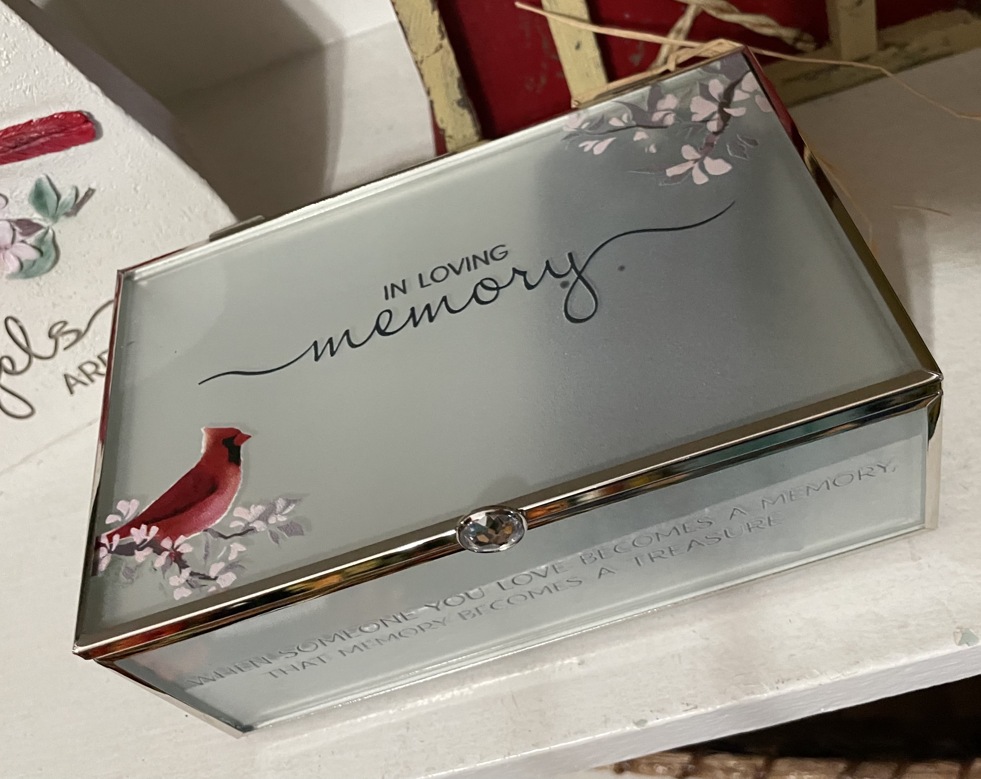 In Loving Memory Box - Remember a life beautifully lived with this keepsake jewelry box. Featuring a glass lined interior ideal for saving cherished mementos from your loved one, The box’s exterior reads, .. In Loving Memory - When someone you love becomes a memory  In Loving Memory - 6" x 3.5" Glass Keepsake Box |   