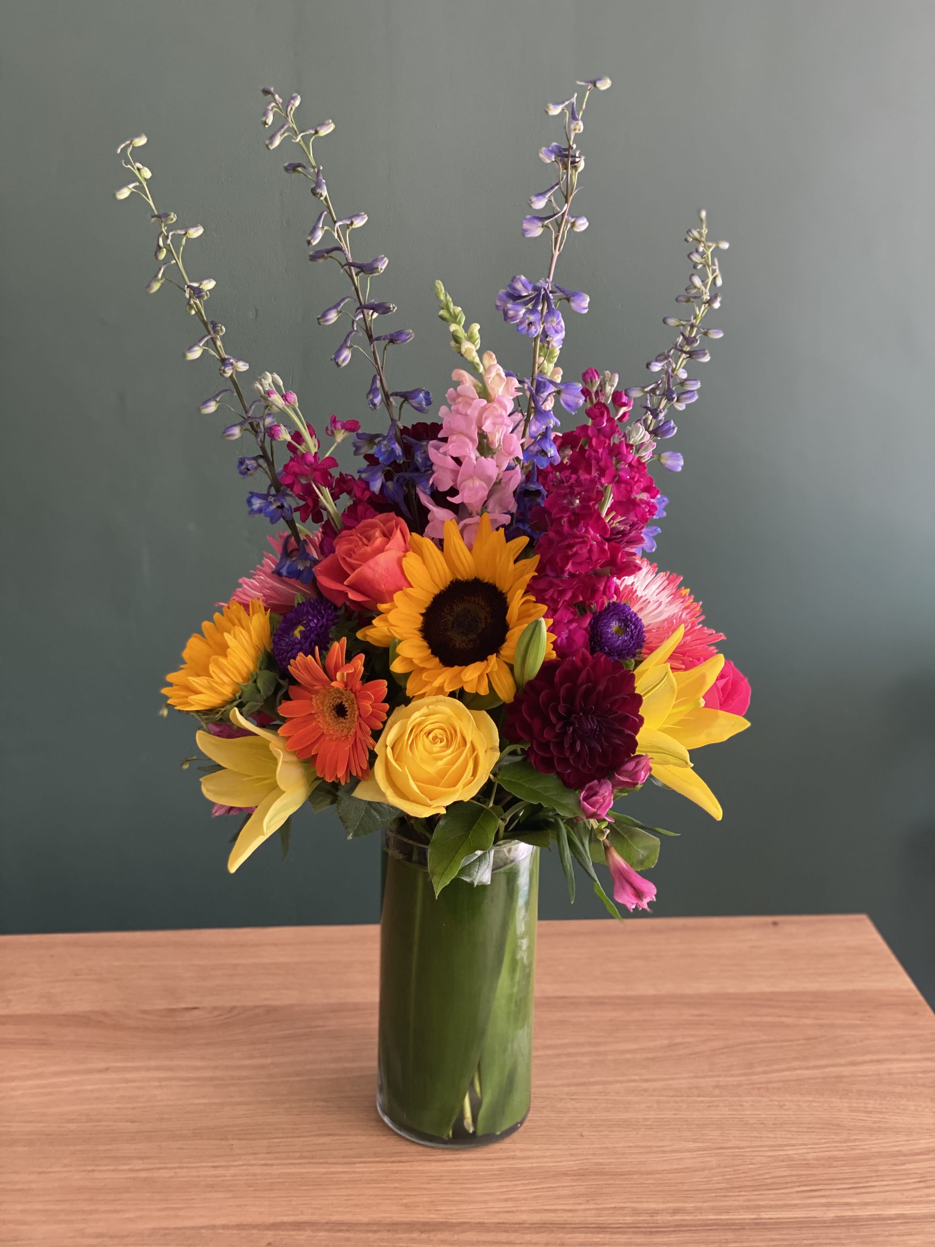Colorful mixed bouquet in a tall glass vase