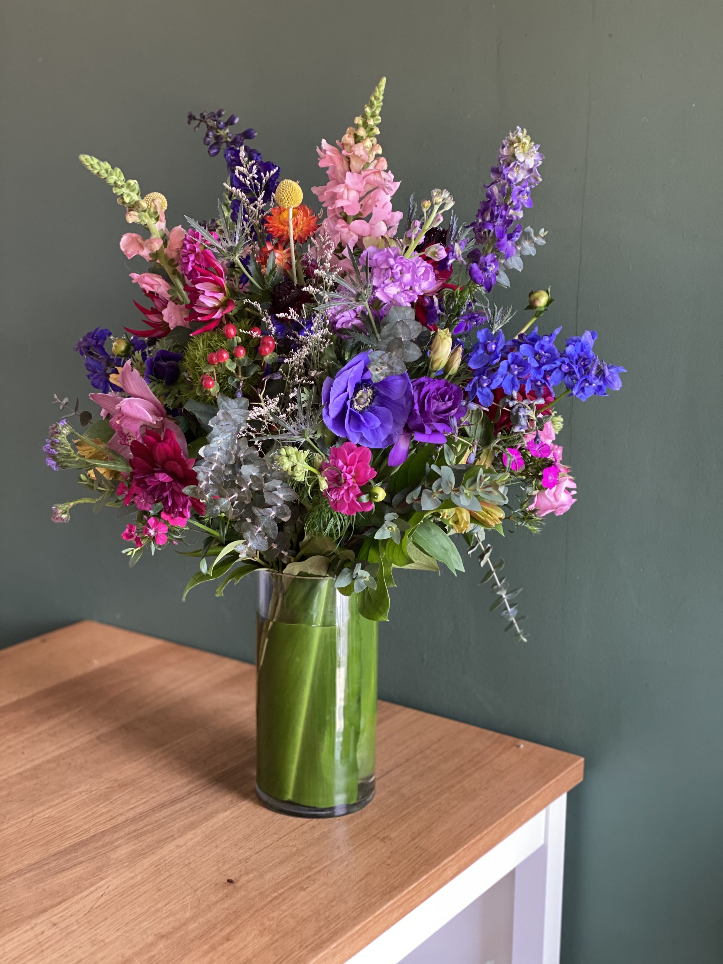 Colorful mixed bouquet in a tall glass vase