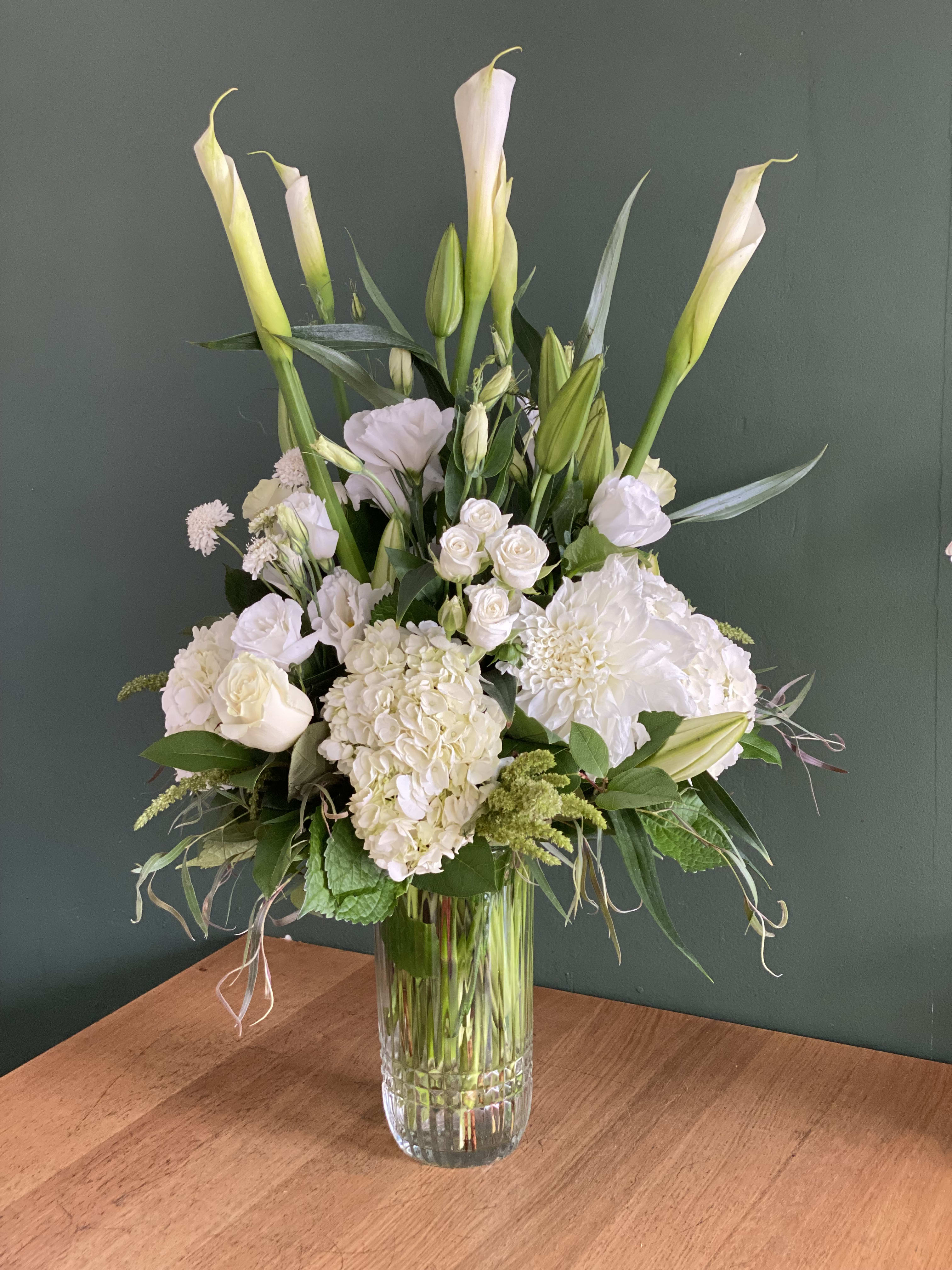 Luv Always - Tall beautiful white floral arrangement, filled with calla lilies, hydrangea, roses, casa blanca lilies, lisianthus and fresh greenery. Elegantly designed in a clear cylinder glass vase. 