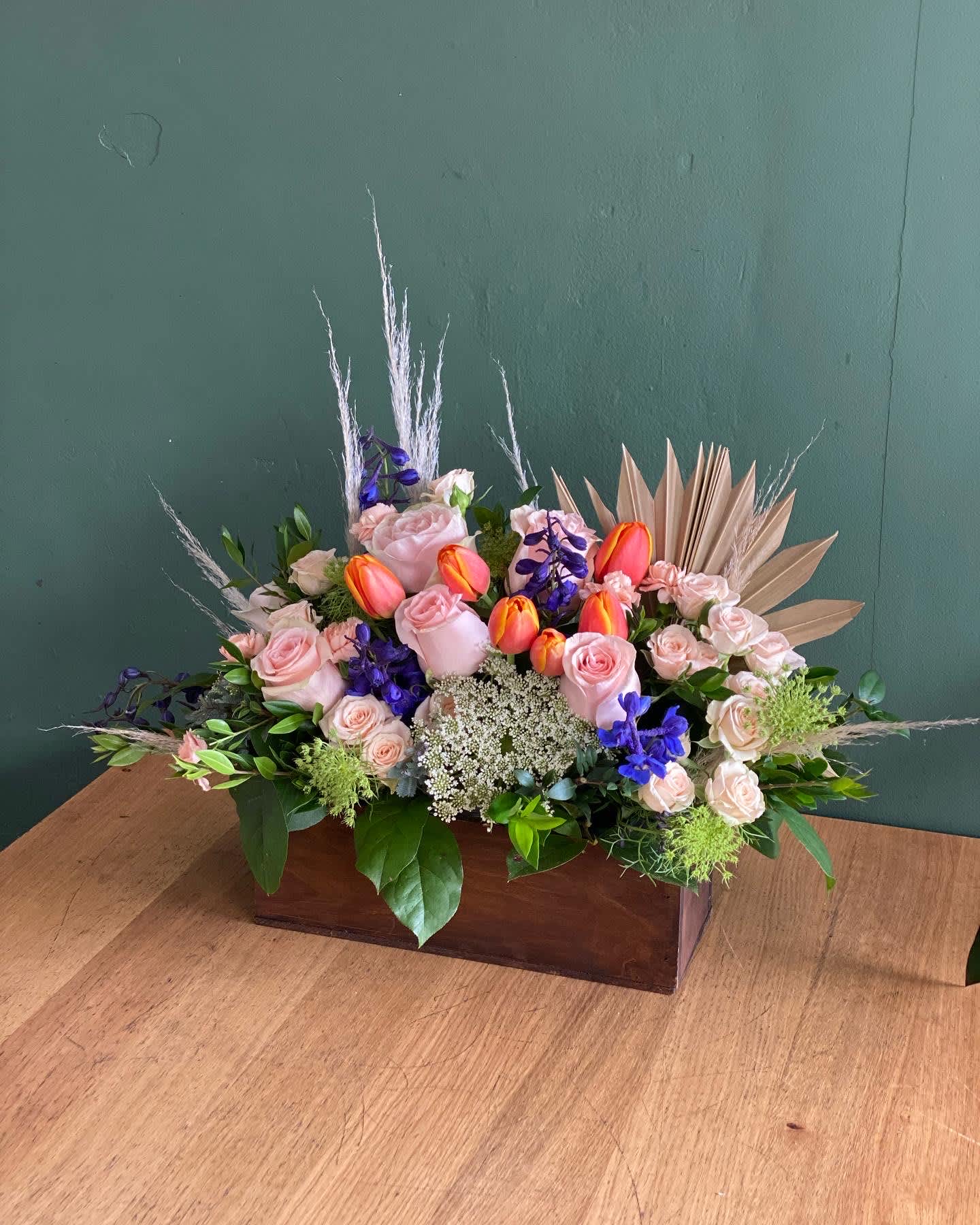 Queen  - Soft color roses arranged in a wooden box.