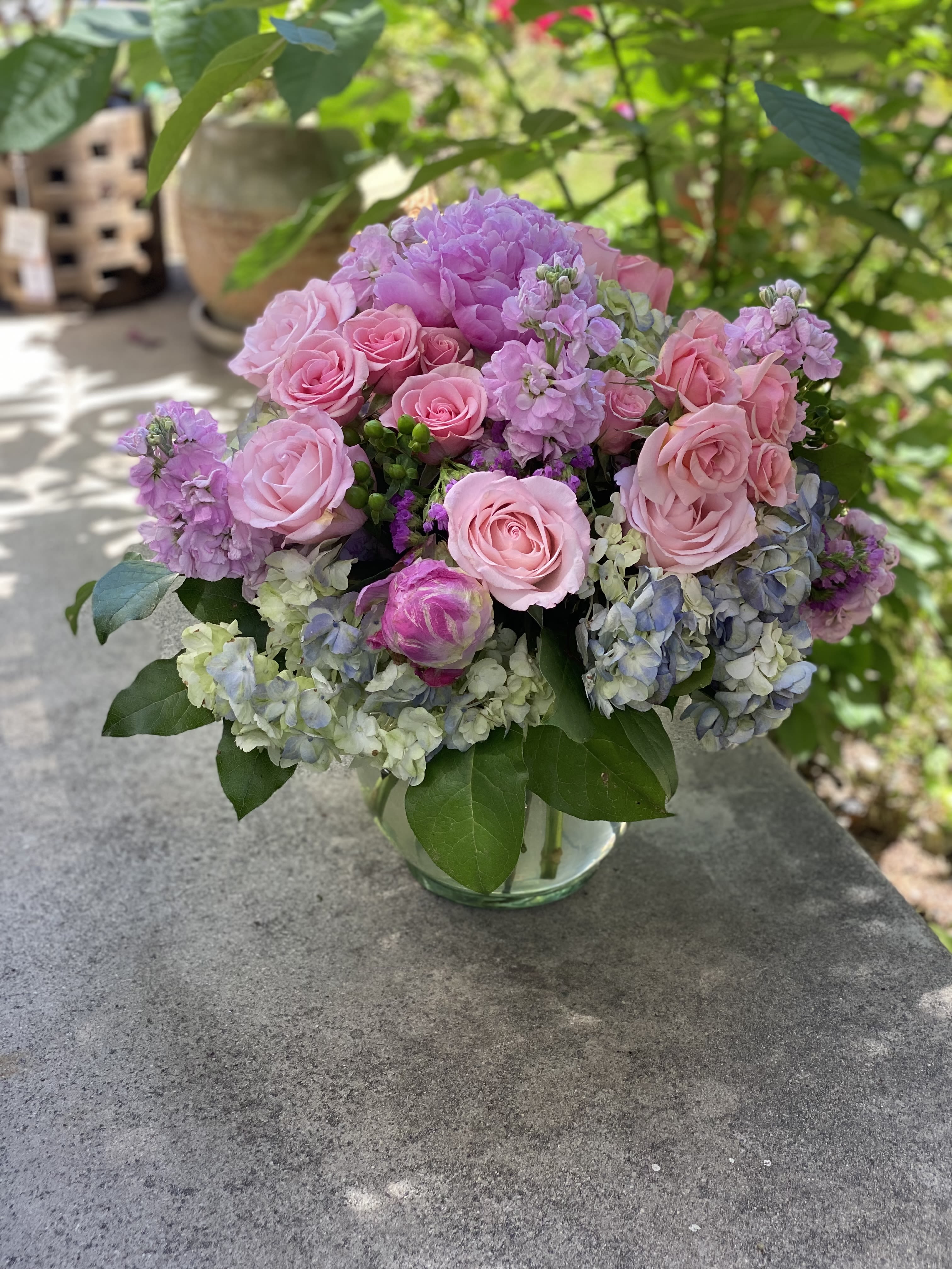 Pink roses and lavender hydrangeas in a glass vase