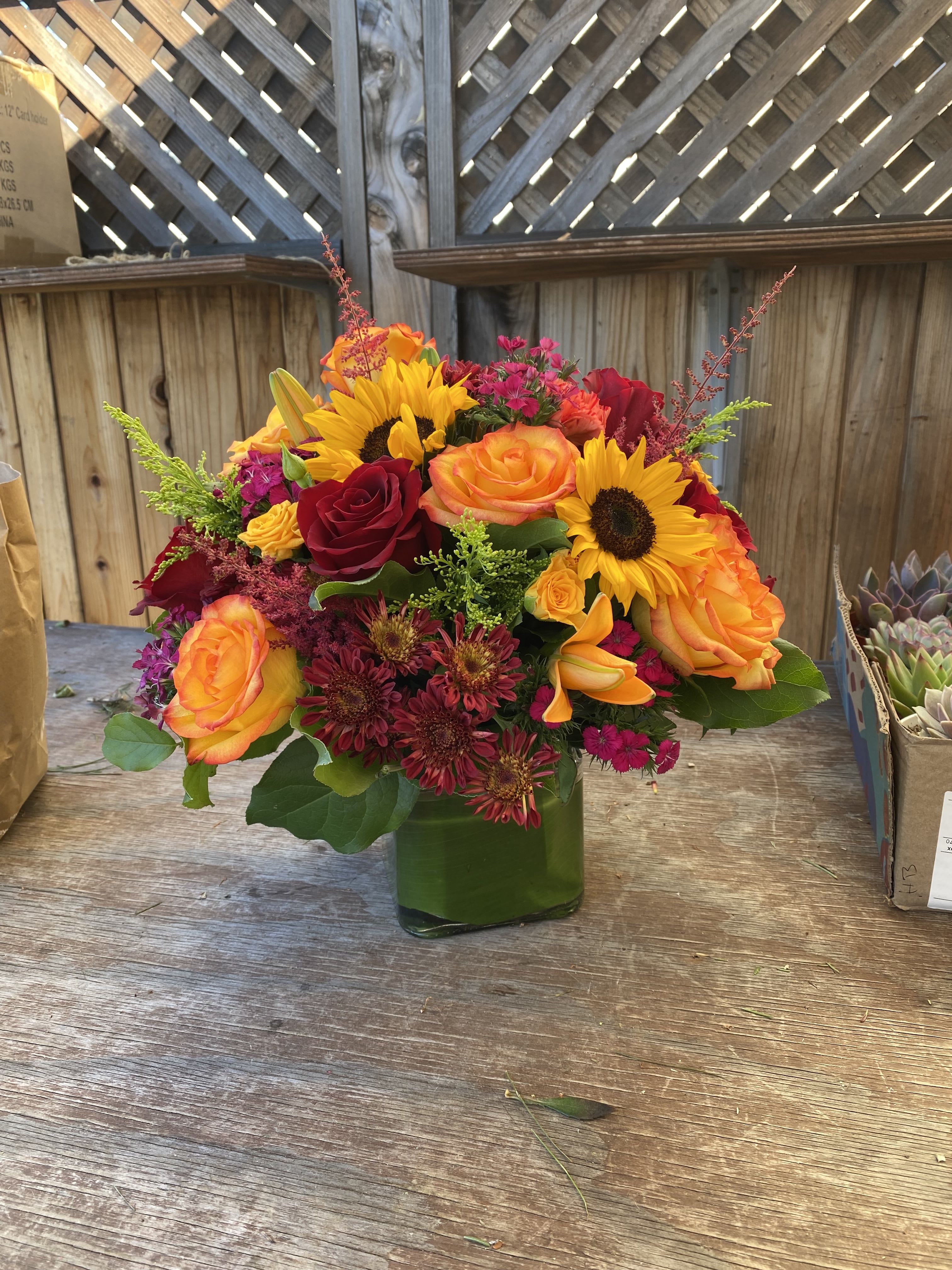 Luz - A bright and cheerful arrangement, with sunflowers, tiger lilies, roses and much more.
