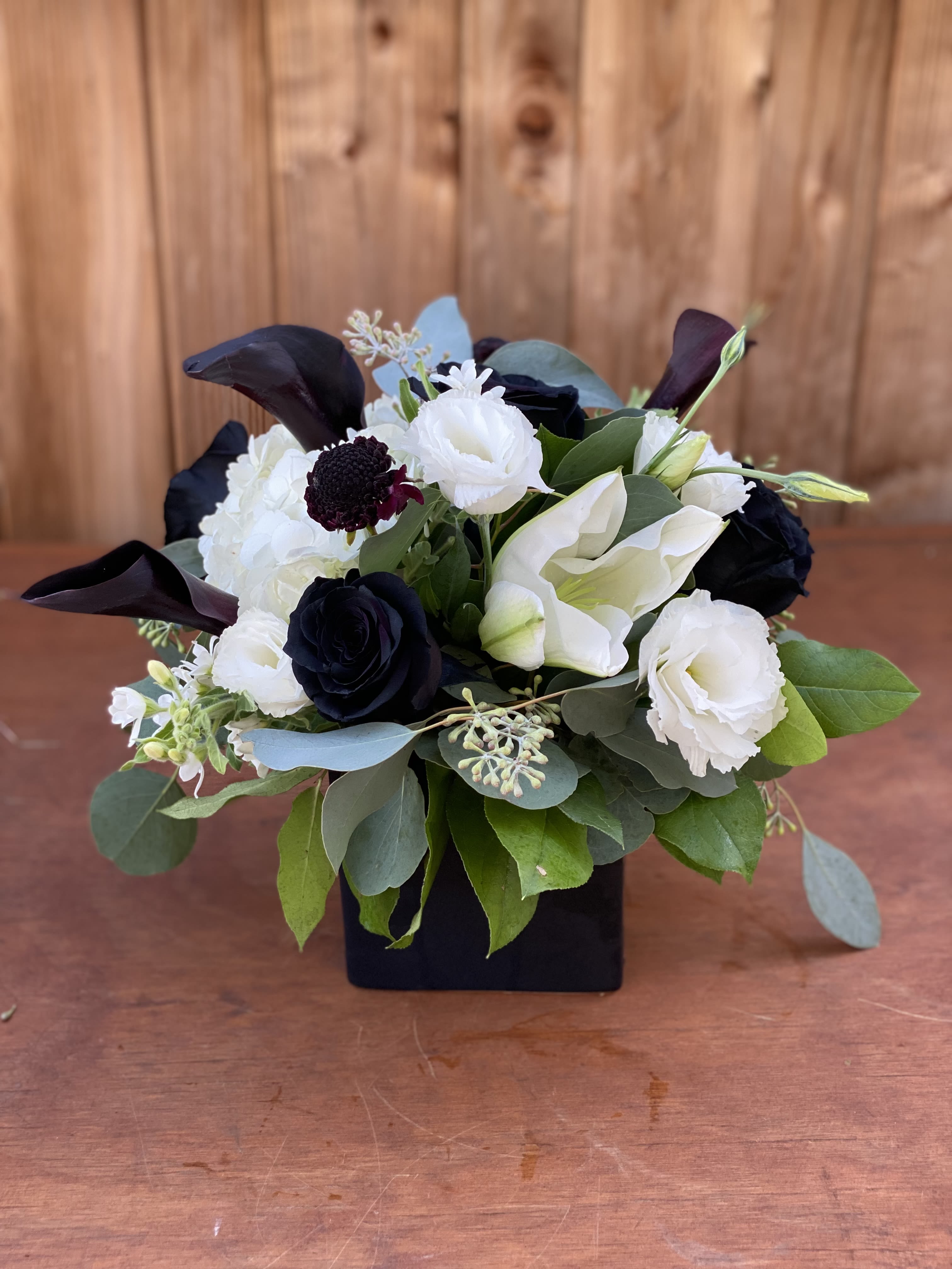 Blk &amp; white - A unique arrangement of black and white flowers. In a black vase 