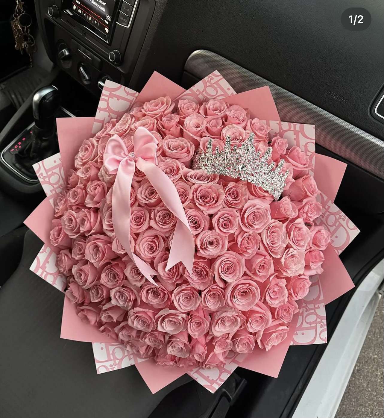 Large bouquet of pink roses with a satin bow and tiara
