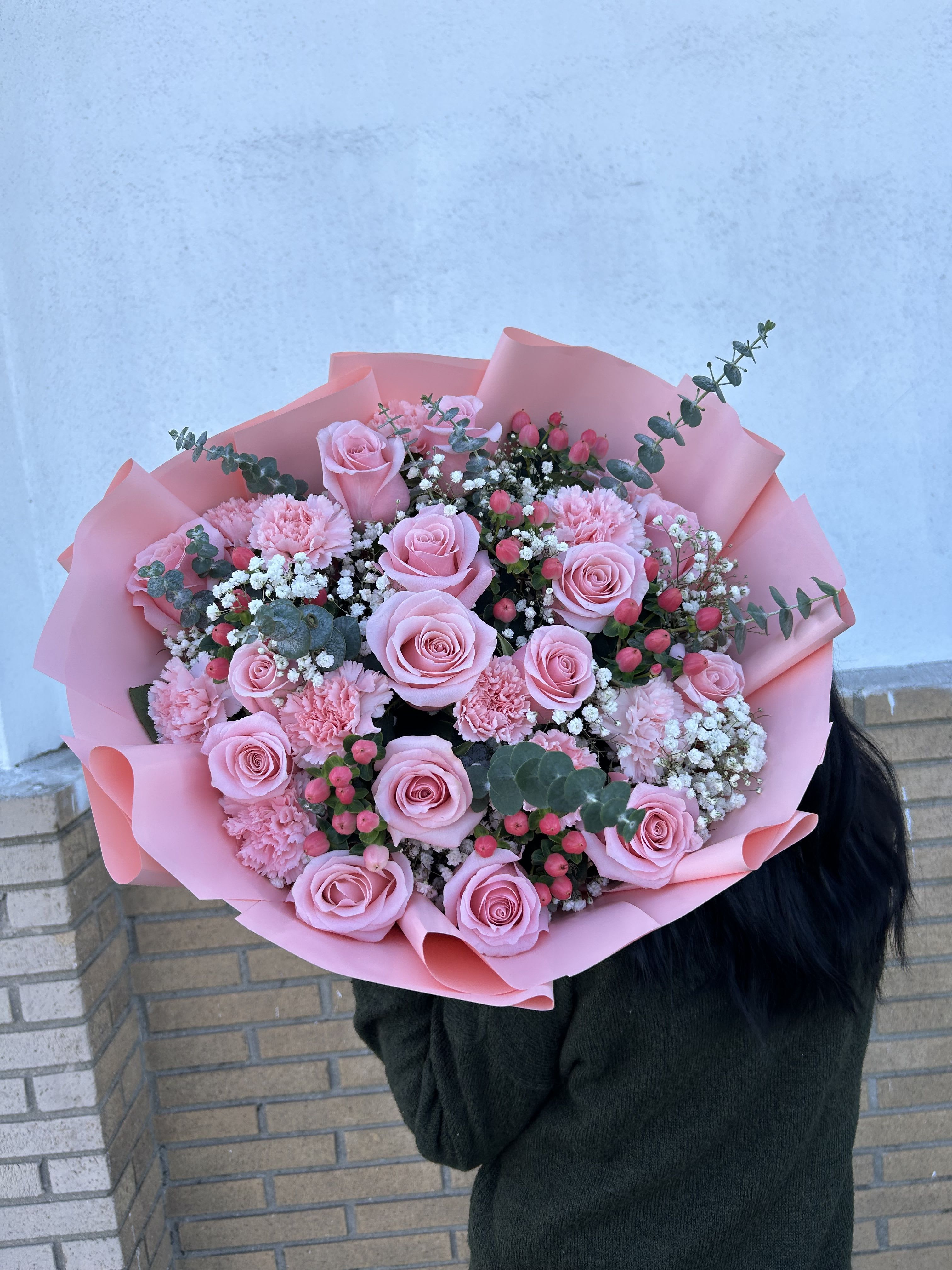Pink rose bouquet with carnations and baby's breath in pink wrap